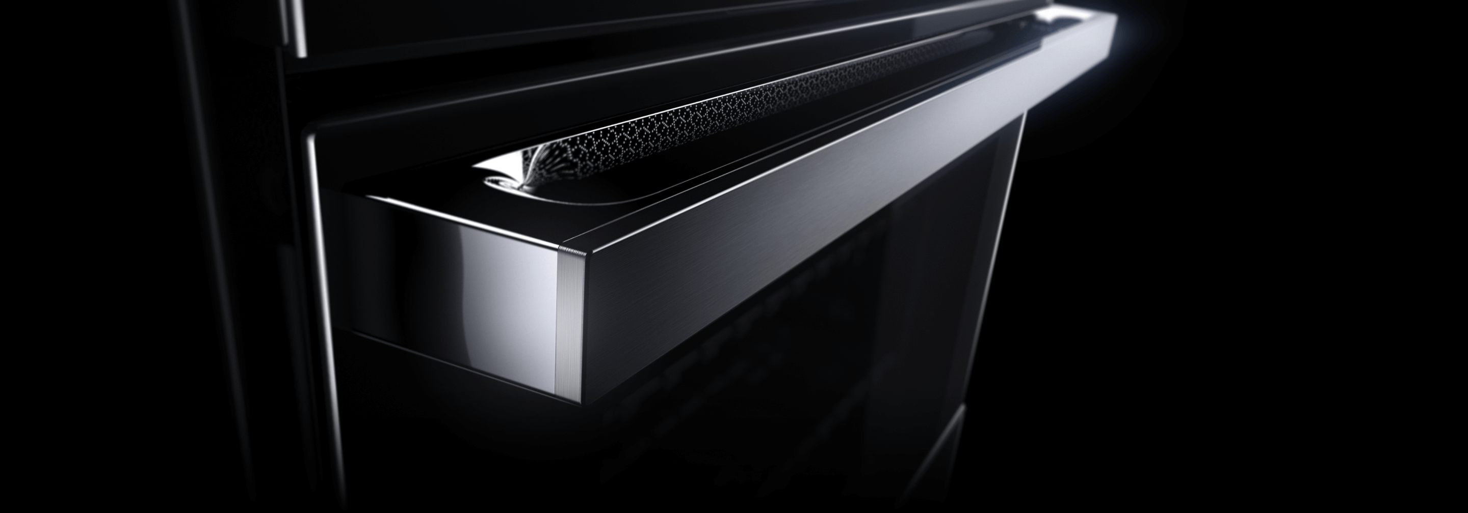 The LCD screen and handle of a JennAir® NOIR™ Design Wall Oven.