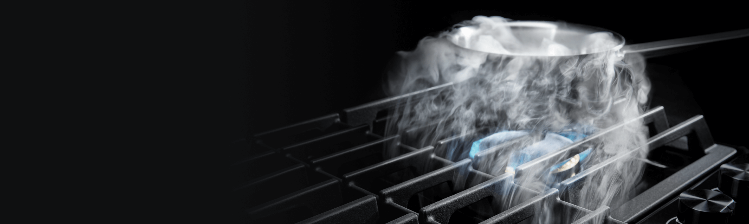 Steam from a pot being pulled by a downdraft vent