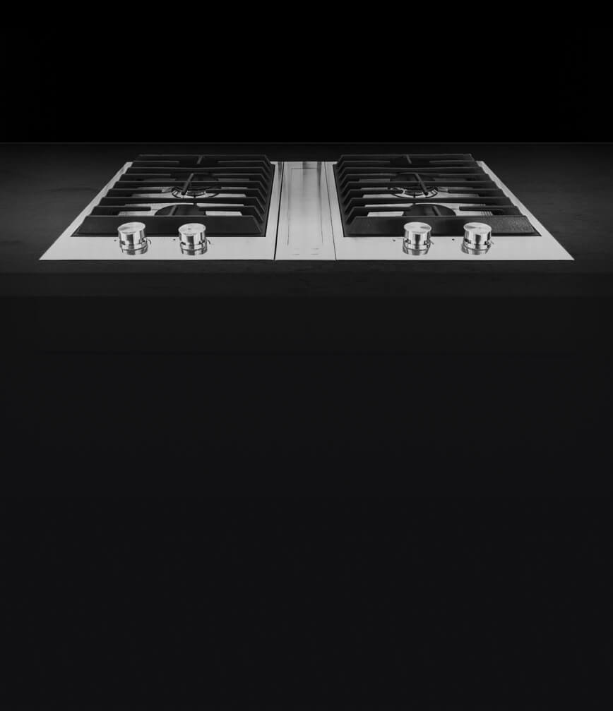 The downdraft vent between two 2-burner gas custom cooktops.