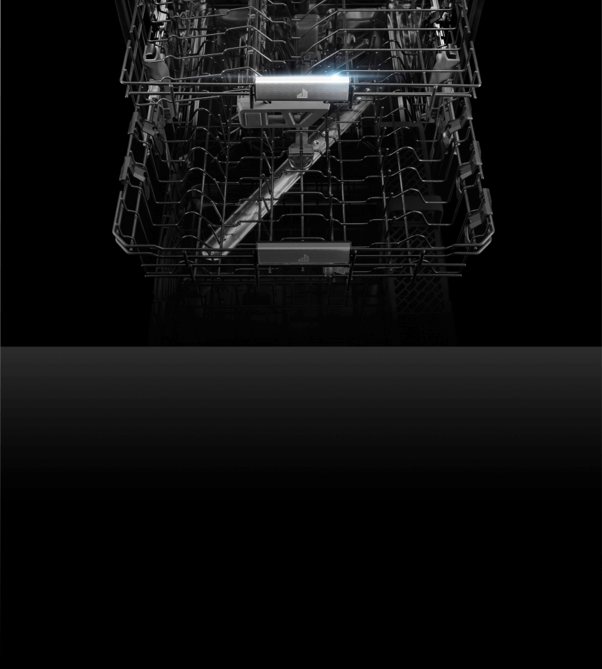 The interior of a JennAir® dishwasher, showing the bottom wash arm.