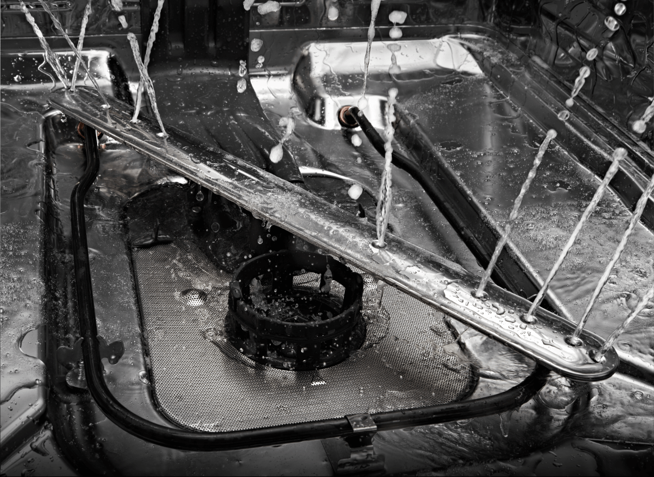 The interior of a JennAir® dishwasher, showing the bottom wash arm.