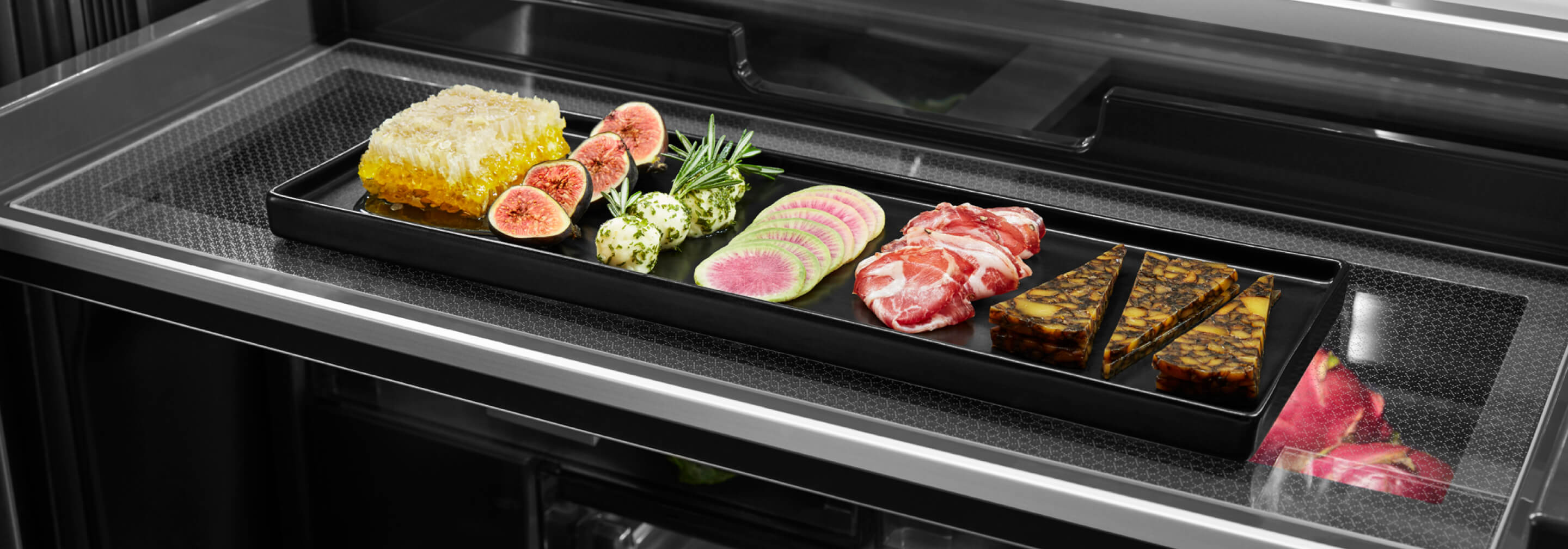 A charcuterie board with fruits, vegetables, meat and cheese inside the Gourmet™ Bay Drawer