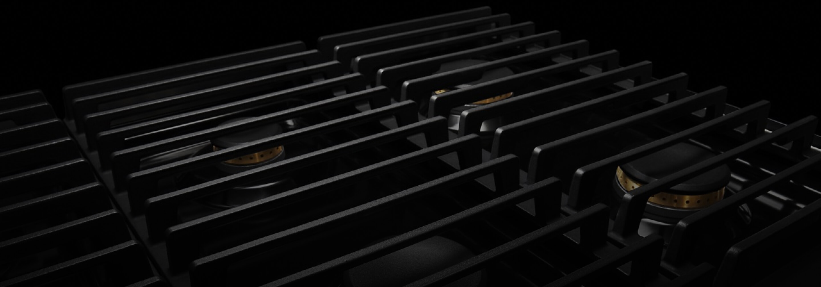 The cast iron grates of a NOIR™ Design gas rangetop.