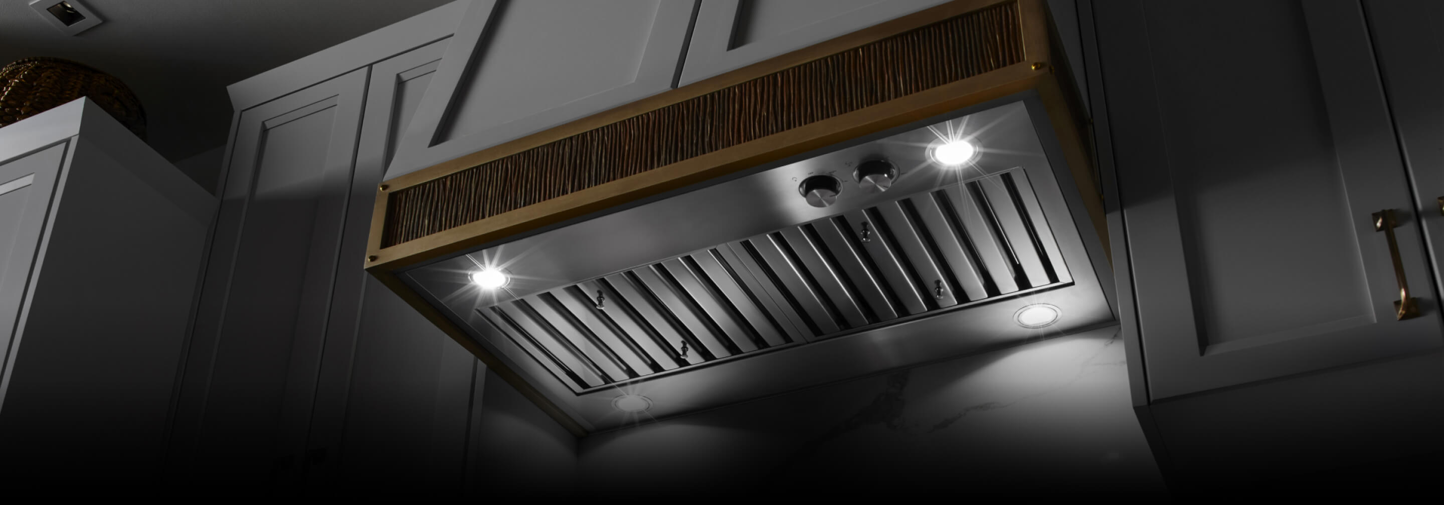 A custom hood liner inside a wooden vent hood facade.