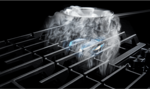 Steam from a pot being pulled by a downdraft vent