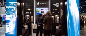 Two people at the JennAir booth at IDS Vancouver.