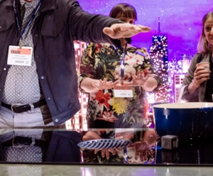 A demonstration of the JennAir Induction Downdraft Cooktop. A man holds his hand over one of the burners.