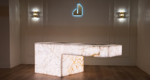 The JennAir Boutique with the JennAir logo on the wall. A lit L-shaped display is in the centre. 