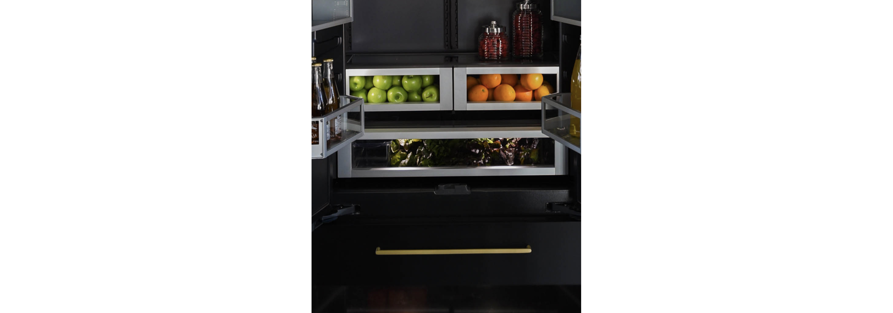 The interior of a JennAir® Built-In Refrigerator with the drawers filled with vibrant produce.