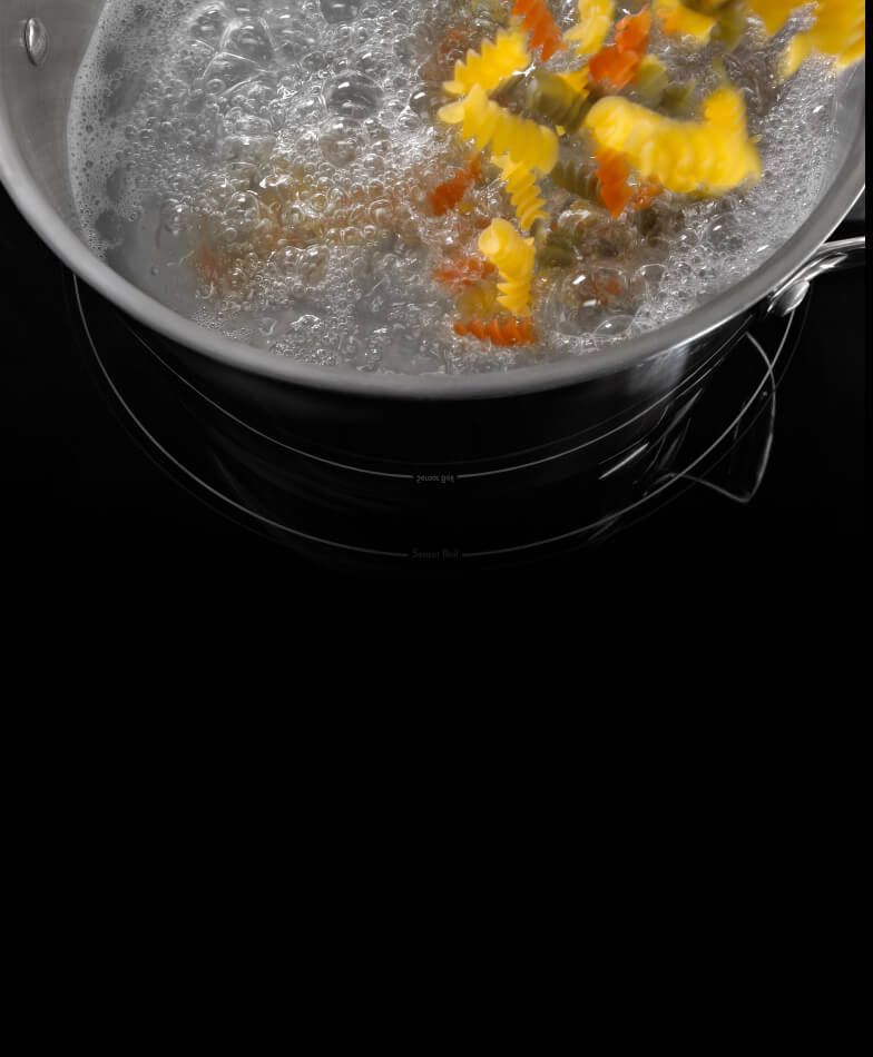 A pan boiling pasta.