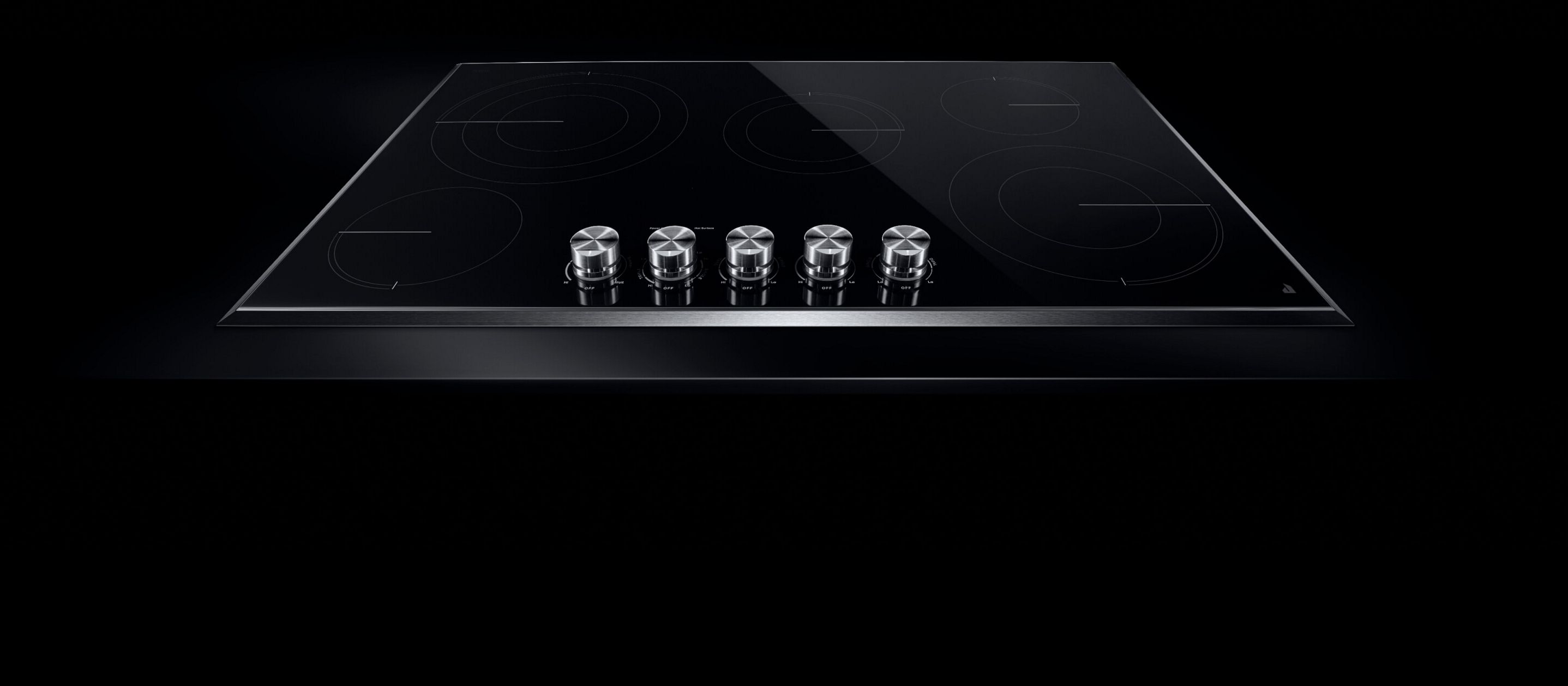 A JennAir® electric radiant cooktop with front knob controls.