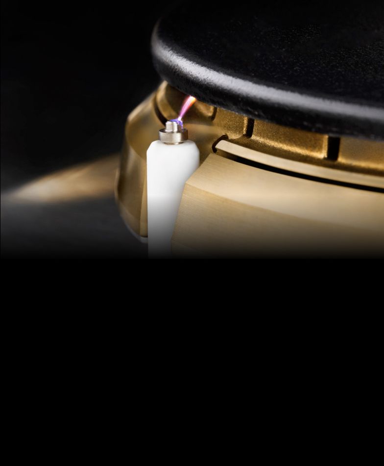 A close up of an igniting JennAir® burner.