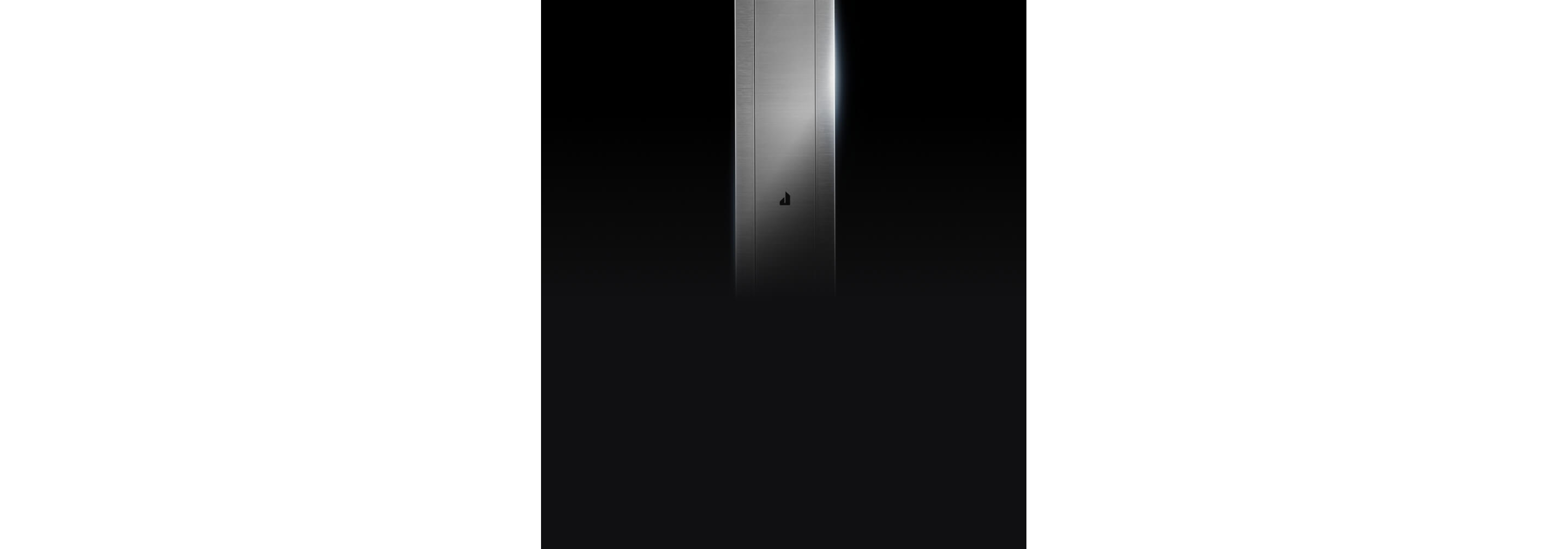 The sleek stainless downdraft vent isolated on a black background.