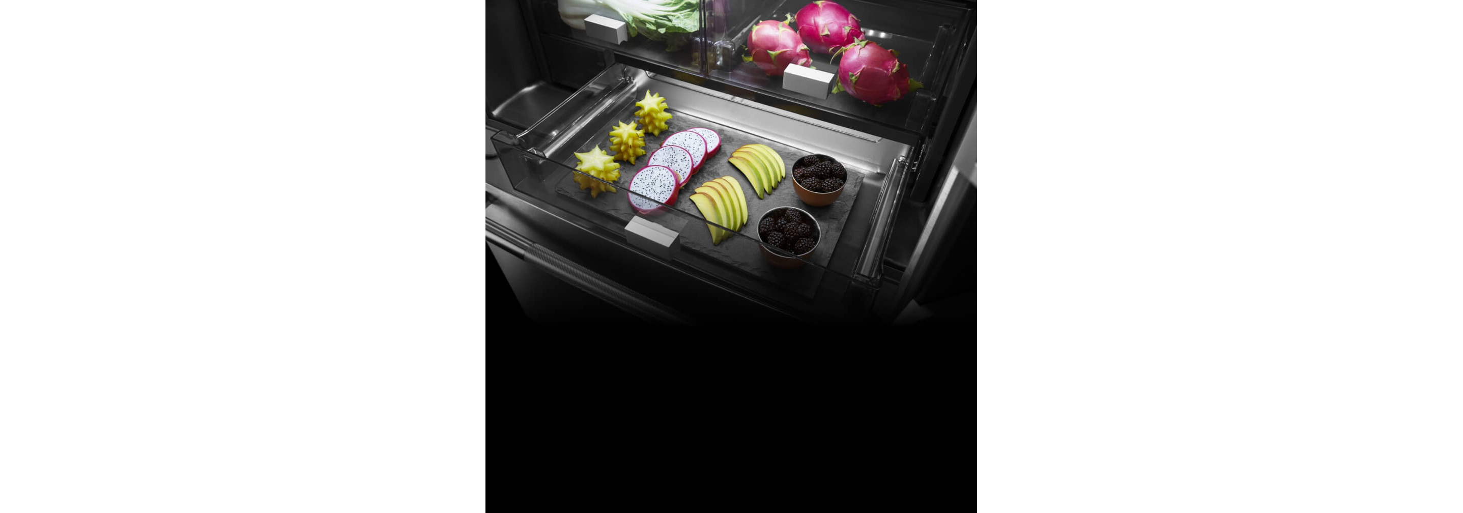 Bright light shining on colorful food inside a refrigerator drawer